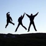 Photo of men jumping for joy