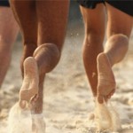 Photo of bare feet running on the sand