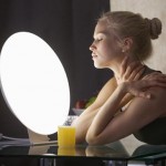 Photo of a woman sitting in front of a light box