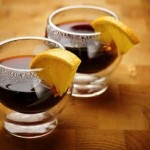 Photo of mulled wine served with lemon wedges