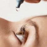 Photo of a woman using eye drops