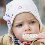 photo of a child eating a rice cake