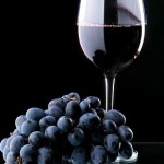 Photo of grapes and a glass of red wine