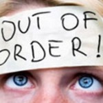 Photo of a woman with an 'out of order' sticker on her head